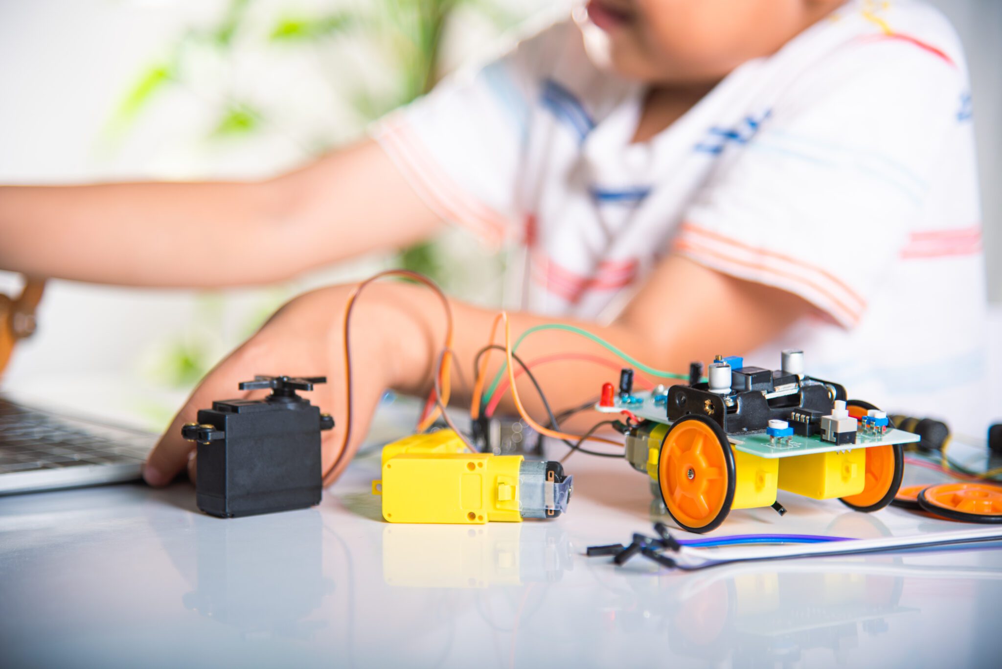 Asian kid boy learns coding and programming with laptop for Ardu - CHUMBAKA
