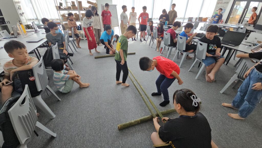 Students in Kuching learning the traditional Bamboo Dance for Gawai Dayak